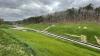 Image of post-construction mine land reclamation shows graded land, growing grass, and drainage infrastructure