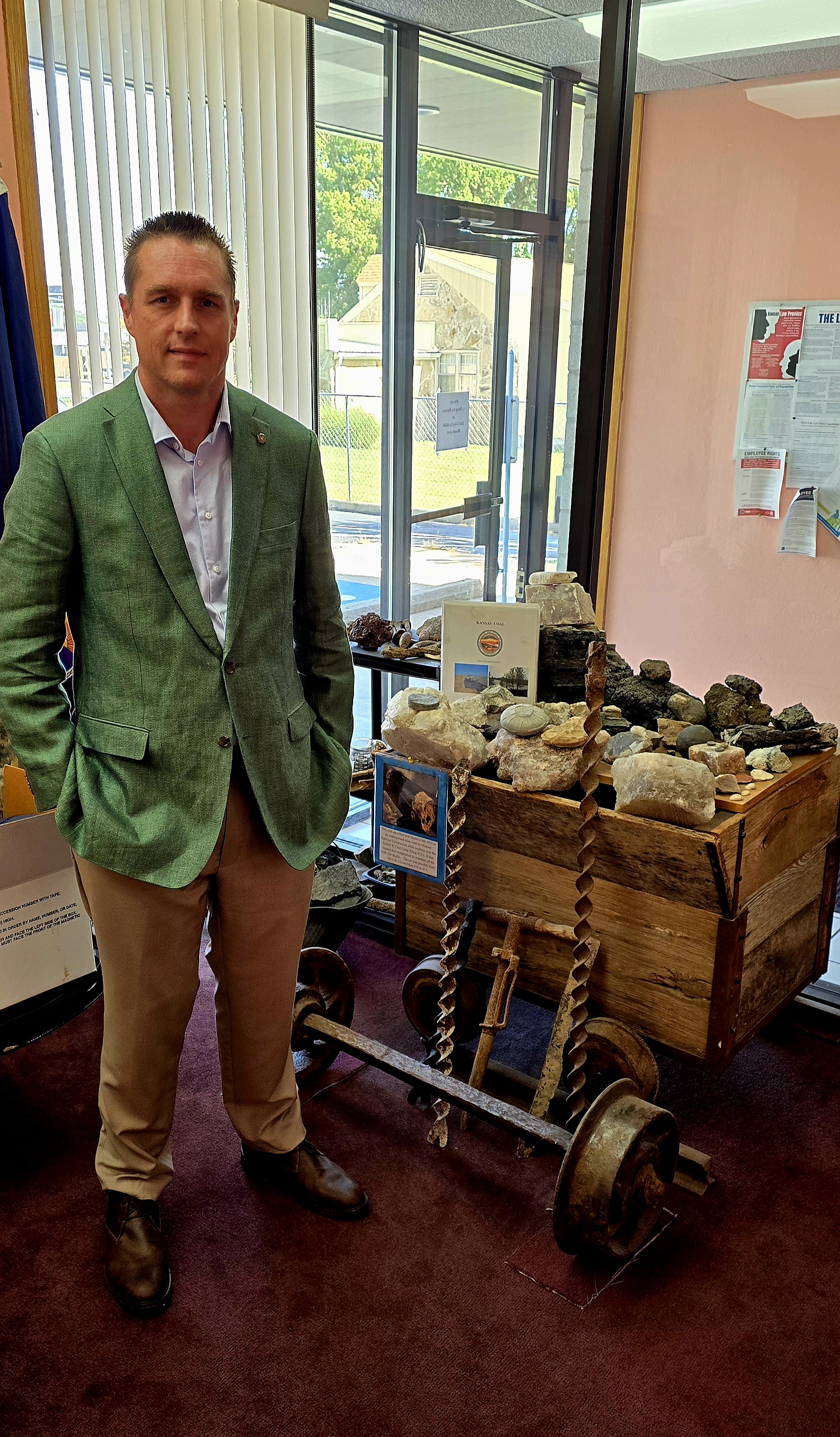 Frank McCoy standing in front of a display soil samples
