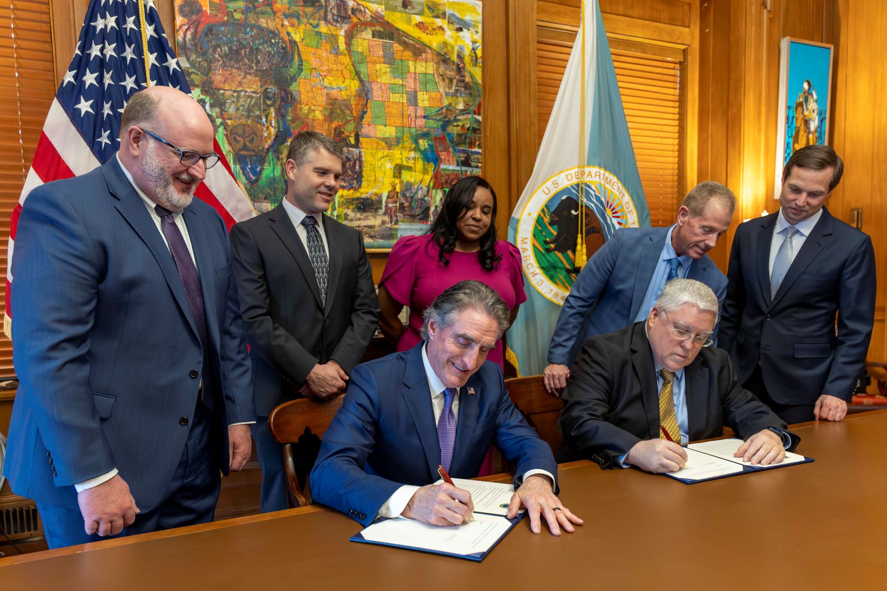 Secretary Doug Burgum, Lanny E. Erdos, Director Office Surface Mining Reclamation and Enforcement, and Governor Patrick Morrisey signing the West Virginia Cooperative Agreement