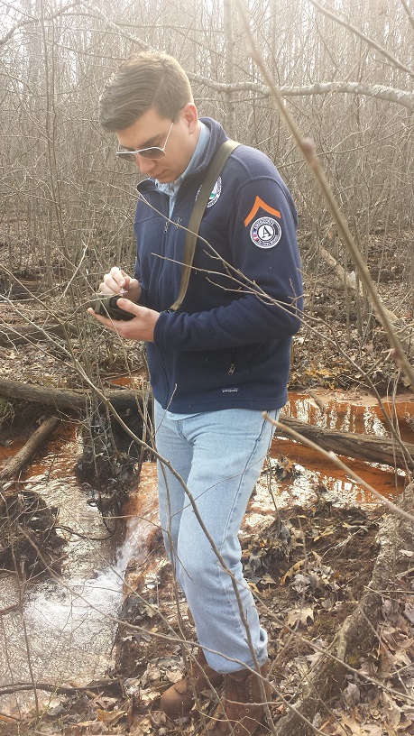 An OSMRE/AmeriCorps Member records data related to acid mine drainage