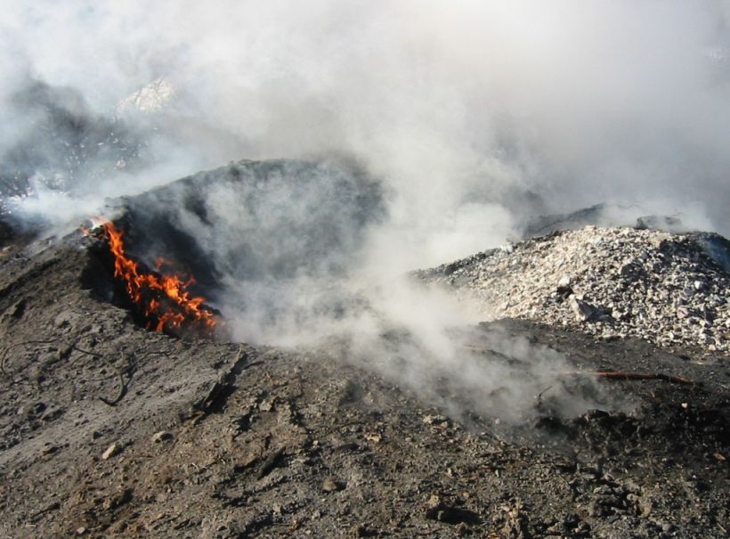 This is an example of a coal waste pile burning. Note how small the flames are.  This is due to the material itself inhibiting the amount of available oxygen for the flame.