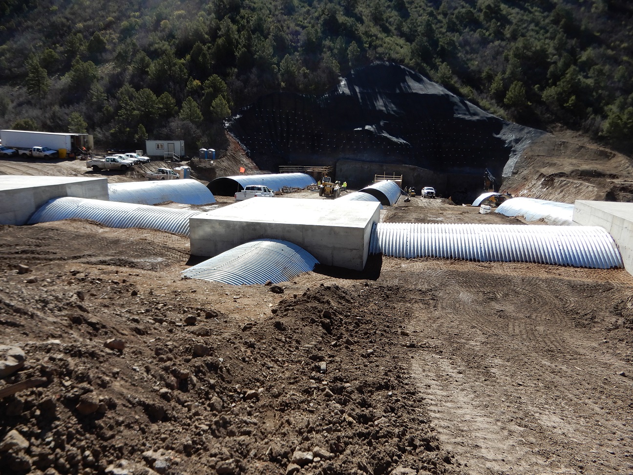 Photograph showing the low-cover crossing at King II Mine. The low-cover crossing is a structure composed of corrugated metal tunnels buried underground to connect underground workings. 