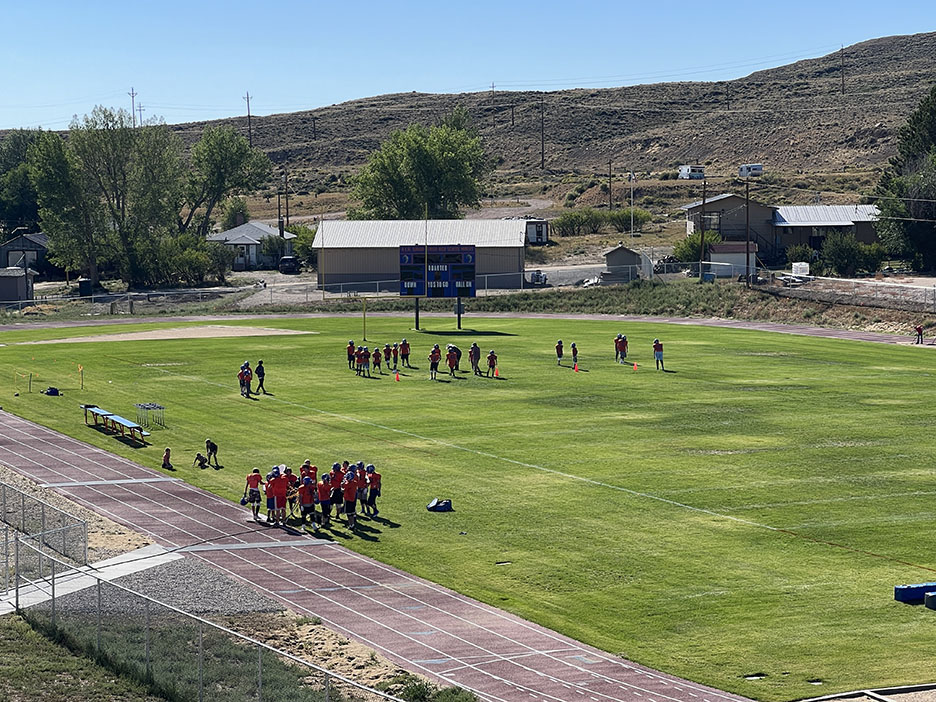 Football players practice on field following mitigation of subsidence.