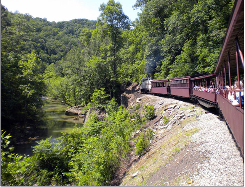 Big South Fork Railway train rides above reclaimed 400 linear foot steel piling wall seated into the bedrock
