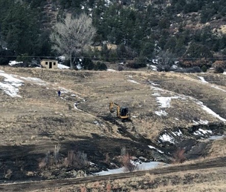 Working on upland erosion control structure      in steep, frozen conditions. Photo courtesy of   New Mexico Abandoned Mine Land Program.