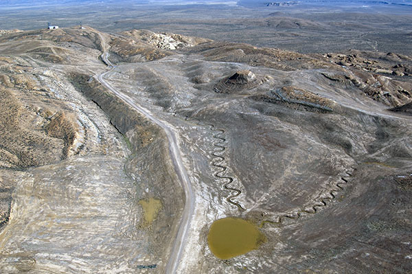 Aerial image of AML reclamation project in Sweetwater, Wyoming. Gray and brown scenery shows improved walls, channels, and roads across gentle hills.