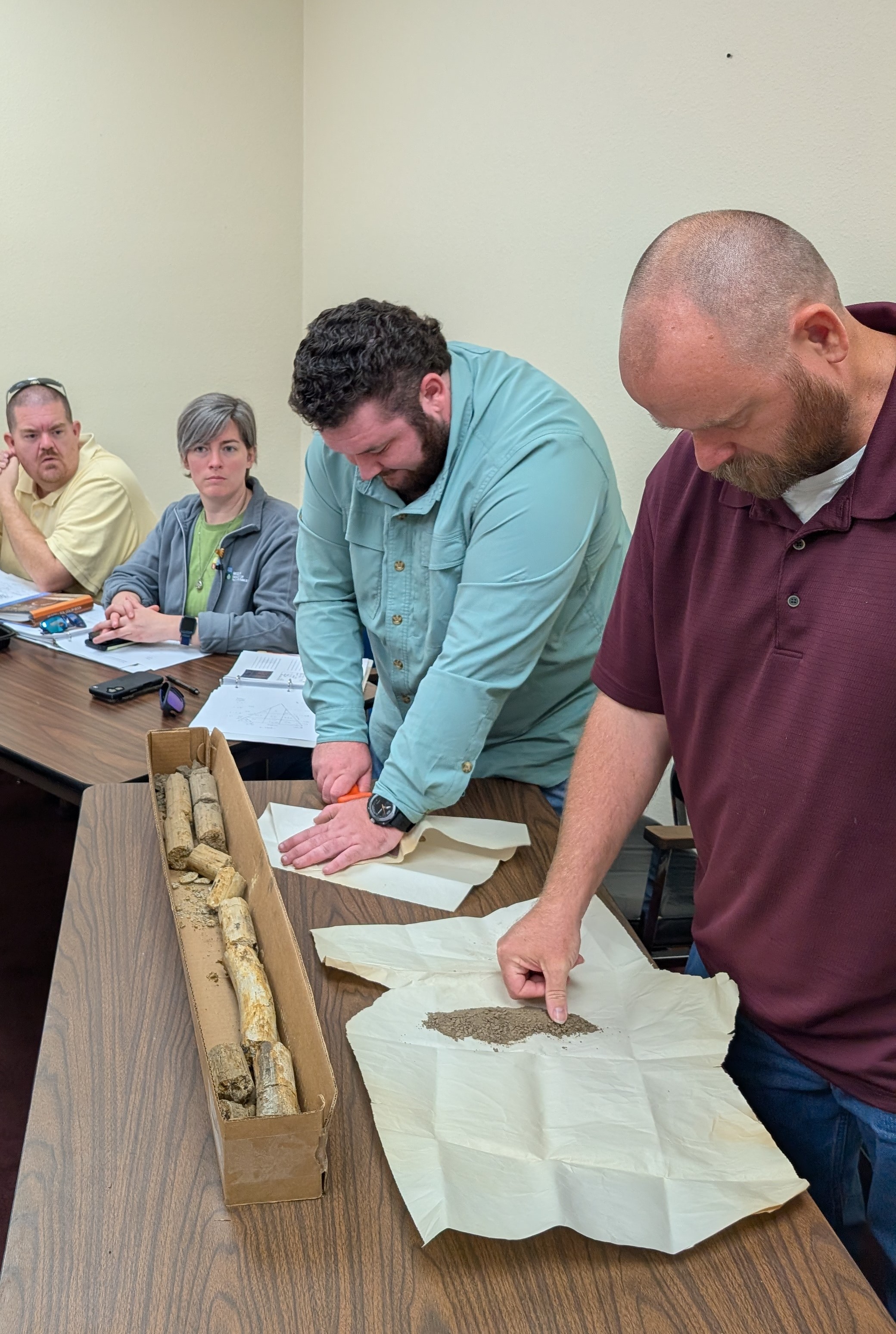 students observing a soil core